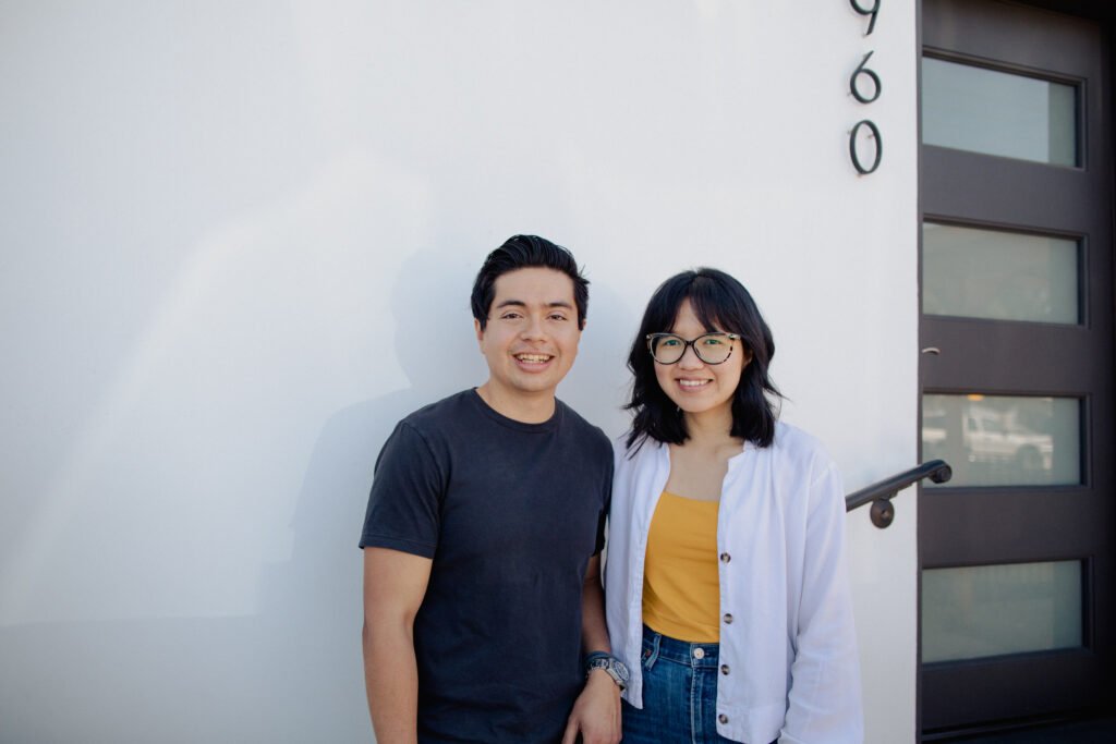 image of a couple architects, the man is wearing a dark blue shirt and the woman is wearing a yellow shirt with a white overskirt